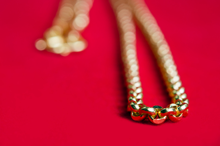 Gold necklace 96.5 precent Thai gold design with gold heart pendant isolated on red flannel cloth...