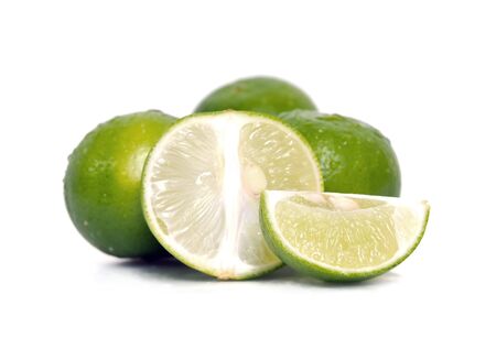 Lemon fruit (Also called as lime, citrus, Persian, or Kaffir fruit) with half cross section isolated on whiteの写真素材