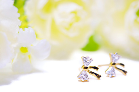 Gold pendant cameo jewellery in diamond bow shape with special Thai gold design with flowers putting isolated on white backgroundの写真素材