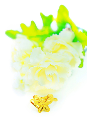 Gold pendant cameo fancy ring jewellery with special Thai gold design in butterfly shape and flowers isolated on white backgroundの写真素材