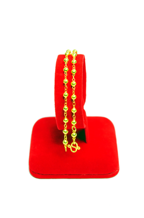 Gold pendant bracelet with special Thai gold design isolated on white backgroundの写真素材