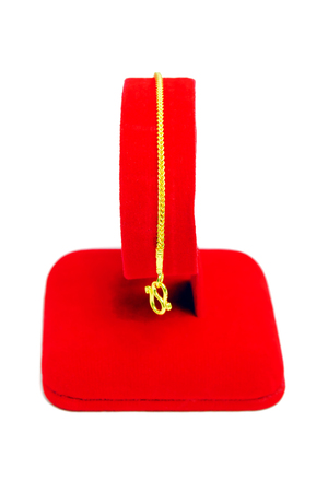 Gold pendant bracelet with special Thai gold design isolated on white backgroundの写真素材