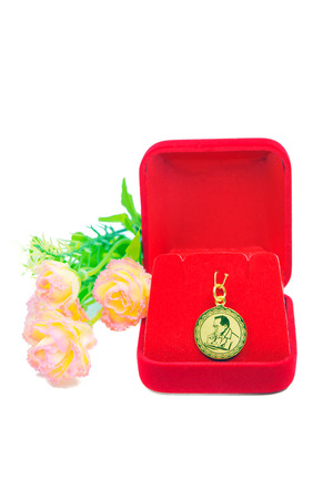 Gold pendant cameo earring jewellery with special Thai gold design and flowers isolated on white backgroundの写真素材