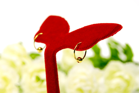 Gold pendant cameo earring jewellery with special Thai gold design and flowers isolated on white backgroundの写真素材