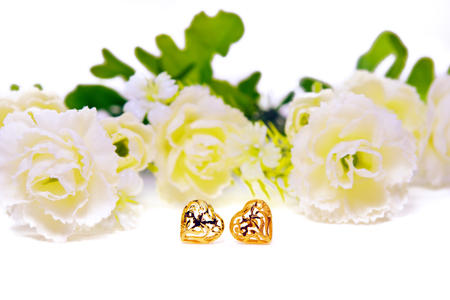 Gold pendant cameo jewellery with special Thai gold heart shape design with flowers isolated on white backgroundの写真素材