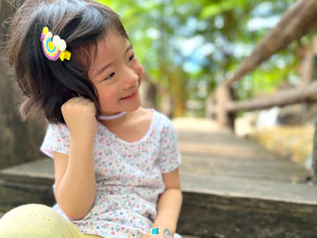 cute little girl smiles in the garden with copy spaceの写真素材