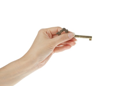 Old golden key on hand isolated on white backgroundの写真素材