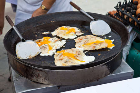 Oysters fried in egg batter being cooked in a panの写真素材