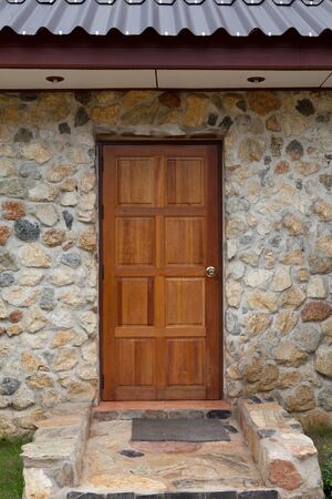 Wooden door on stoned houseの写真素材
