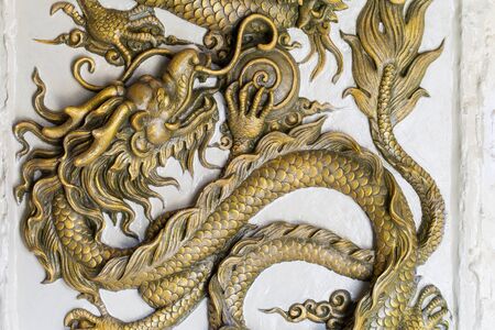 Dragon Sculpture on a wallの写真素材