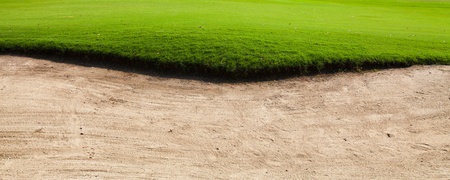 Sand bunker on the golf course with green grassの写真素材