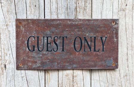 Closeup Guest Only Sign on wooden door