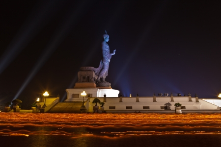 Makha Bucha Day at Phutthamonthon in Thailand. People walking pass the side of stand buddha in wian tian ceremonyの写真素材