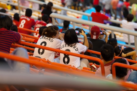 BANGKOK - JULY 28   Liverpool fan wear white shirt with the word Gerrard during match between Thai National team and Liverpool FC in LFC Tour 2013 tournament in Bangkok, Thailand during 25-28 July 2013のeditorial素材