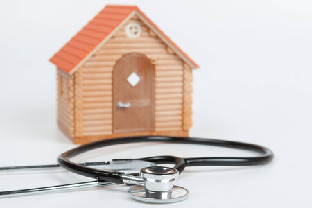 Stethoscope and Model House on white backgroundの写真素材