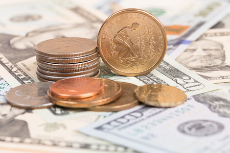 US coins on US banknotes close up