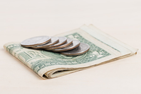 used US banknotes on wood table close upの写真素材