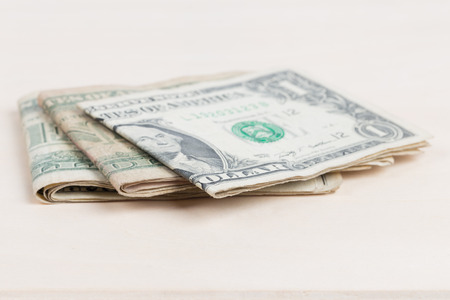 used US banknotes on wood table close upの写真素材