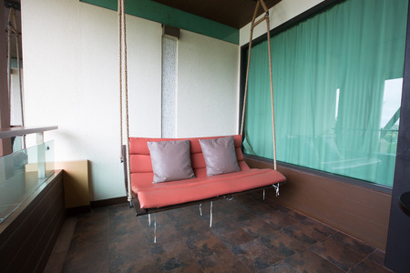 Luxury swinging sofa in a balconyの写真素材