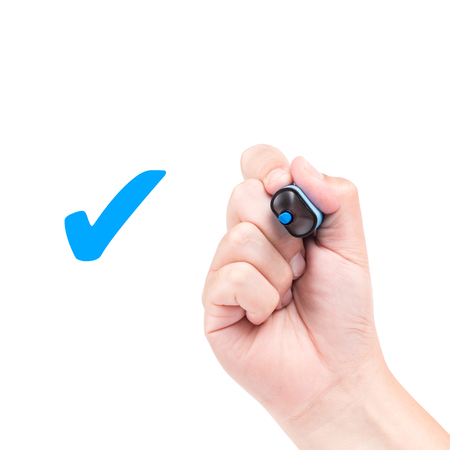 Right hand with blue marker draw a check mark isolated on white backgroundの写真素材