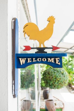 Grunge wooden welcome sign attach to restaurant front doorの写真素材