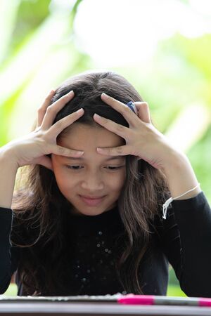 Cute girl has problem with her homeworkの写真素材