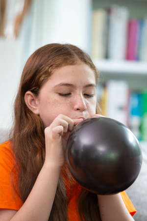 Happy Halloween, a girl prepare the colorful balloon in decorated houseの写真素材