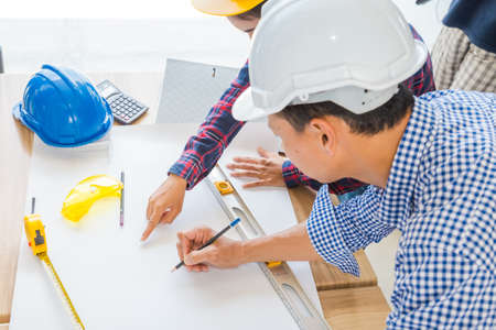 Group of architects woking on blank blueprint