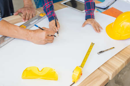 Group of architects woking on blank blueprint