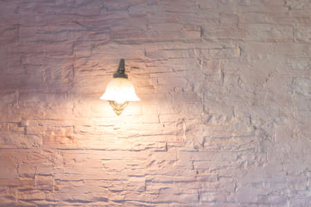 Brick wall with lamp turn onの写真素材