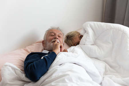 Grandfather ask to keep silence while grandmother is going to sleepの写真素材