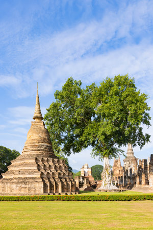 Ancient Buddha statue and ruin of temple of Wat mahathat temple in Sukhothai Historical Park, which also one of UNESCO Heritage Siteの写真素材