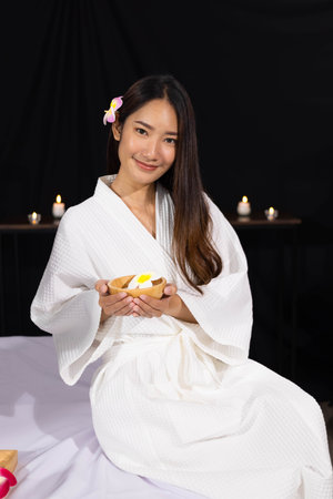 An Asian girl is smiling and relax in spa salonの写真素材