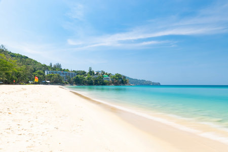 Long exposure shot of Surin beach with blue sky during a sunny day, one of the tourist destination in Phuket, Thailandの写真素材