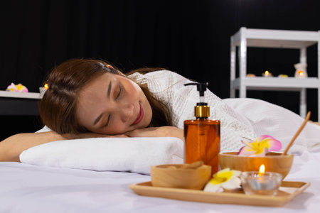 An Asian girl sleep with smile and relaxing in spa salonの写真素材