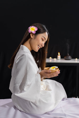 An Asian girl is smiling and relax in spa salonの写真素材