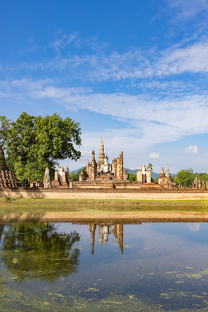 Ancient Buddha statue and ruin of temple of Wat mahathat temple in Sukhothai Historical Park, which also one of UNESCO Heritage Siteの写真素材