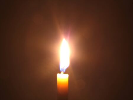 One candle lit at nightの写真素材