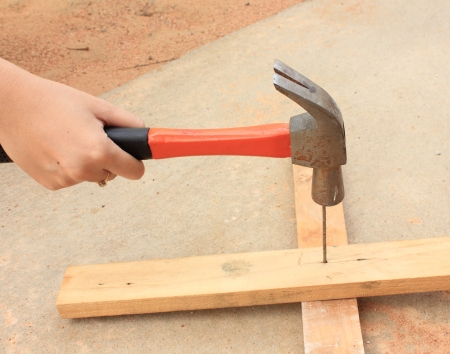 Close up view of hammer being used to hammer a nailの写真素材