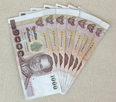 Thai money baht on tiled floorの写真素材