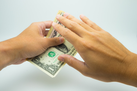 A hand grab a USD bank note a hand deny itの写真素材