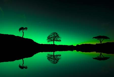 Northern lights Aurora borealis reflection on a lakeの写真素材