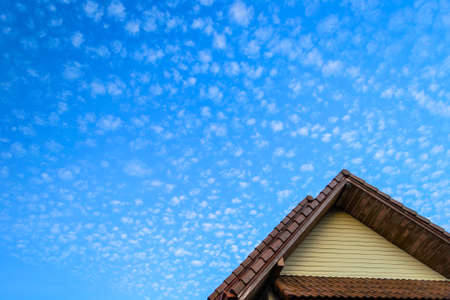 Bright day with strange cloud above the house roof