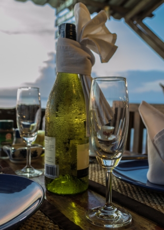 Setting dining table with white wine in the eveningの写真素材