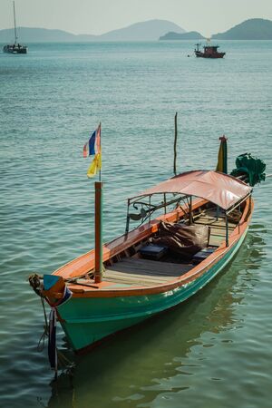A green long tail boat at panwa cape, phuketの写真素材