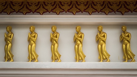 Buddha image on the wall which is decorated in a templeの写真素材