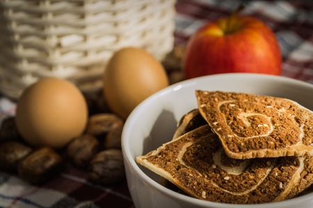 cookies, apple and eggs with basket on the clothの写真素材