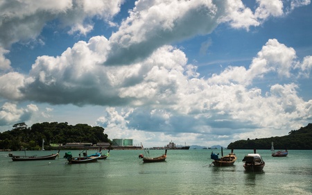 many fishing boat on the sea with cloudy sky in the morningの写真素材