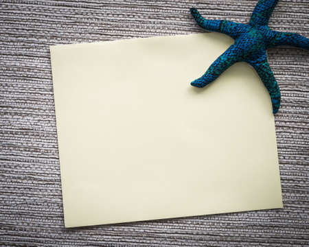 close up of a vintage note paper on fabric backgroundの写真素材