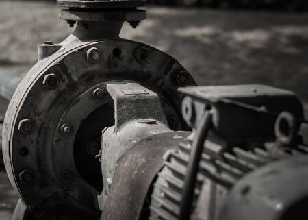 close up old rust water pump under sunlightの写真素材